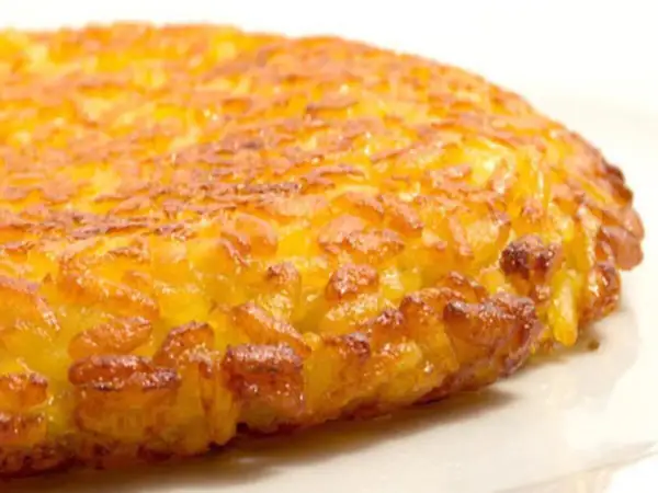 Una dorata frittata di riso, croccante fuori e morbida dentro, pronta per essere gustata.
